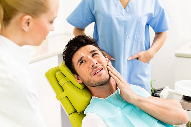 Person experiencing tooth pain in Burlington
